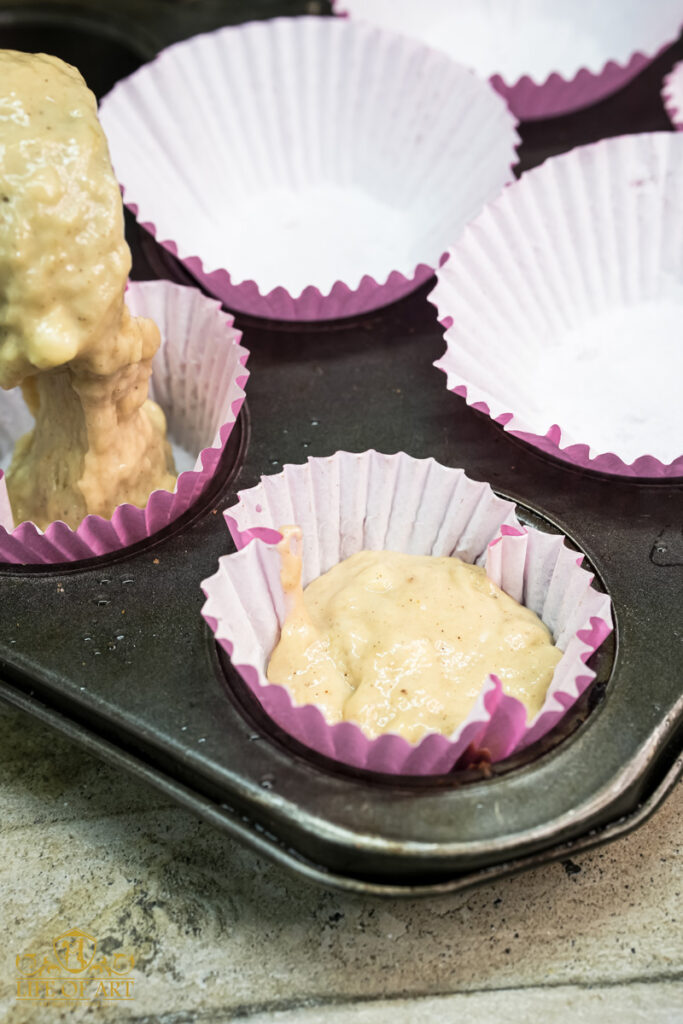Filling muffin liners with banana muffin batter