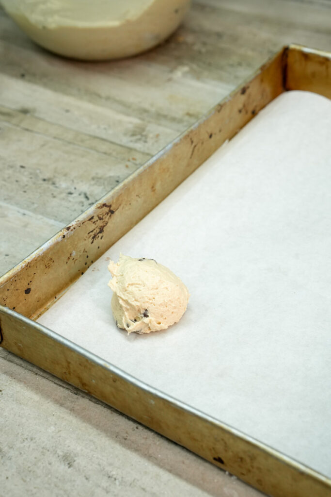 First scoop of cookie dough on a baking sheet