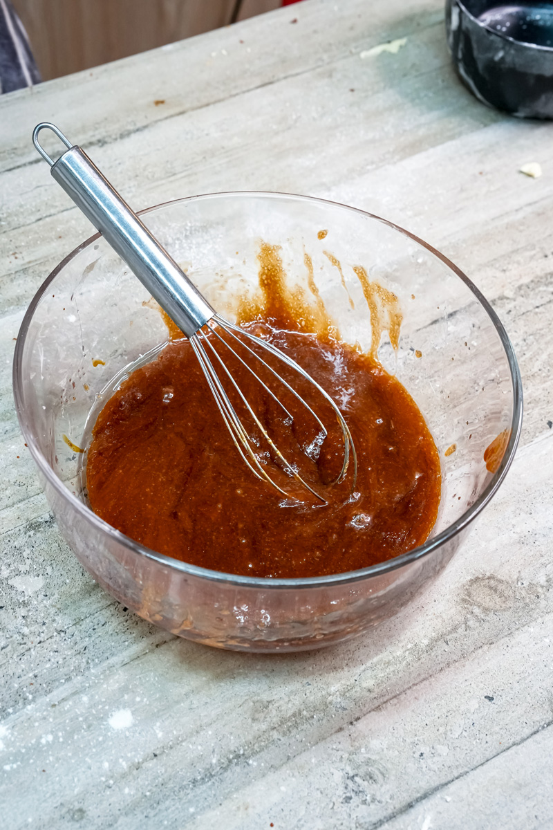 Whisking molasses cookie batter until smooth