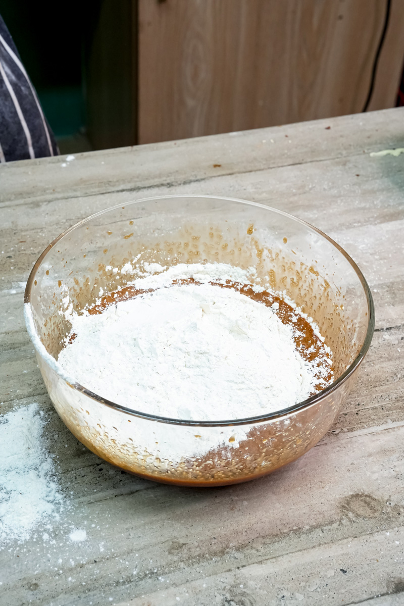 Flour and dry ingredients mixed in glass bowl for cookies