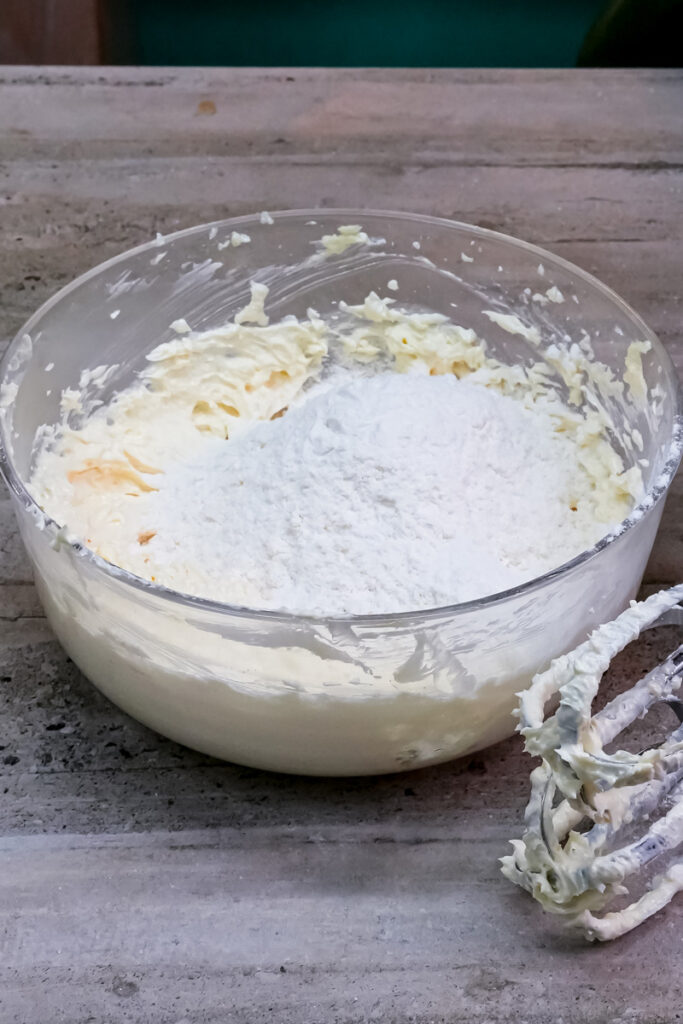 Flour being added to the wet ingredients for the cookie dough