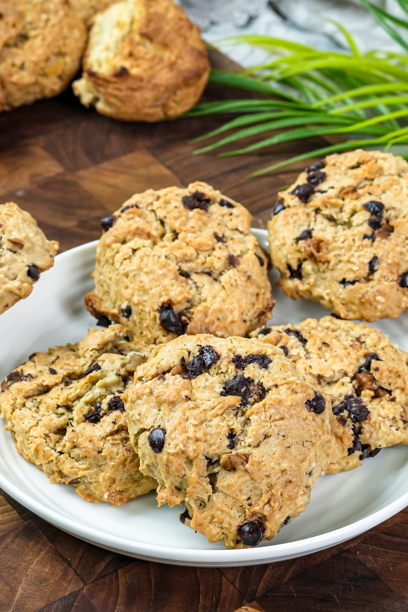 Freshly baked cowboy cookies on white plate with oats and chocolate chips