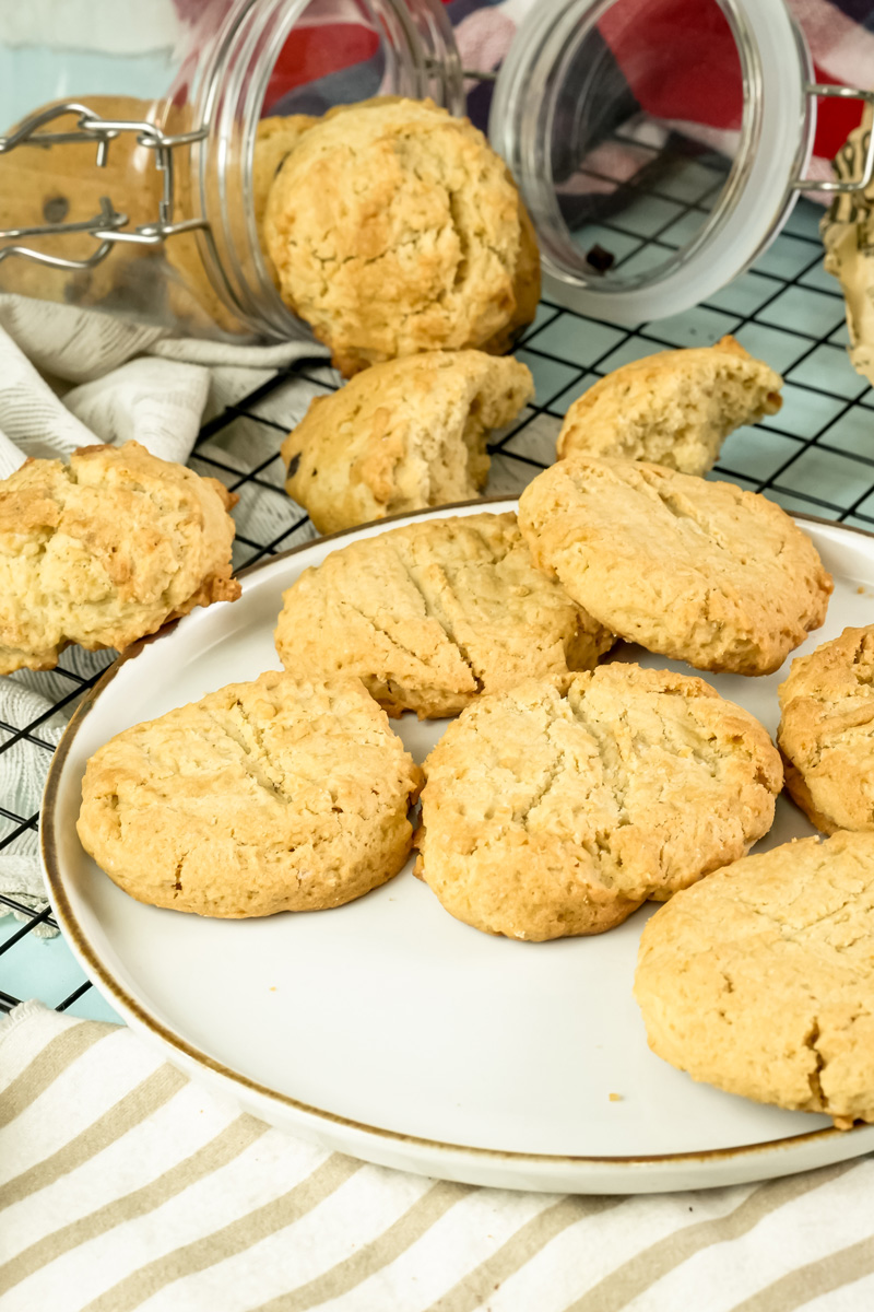 Freshly baked peanut butter cookies on a plate and cooling rack