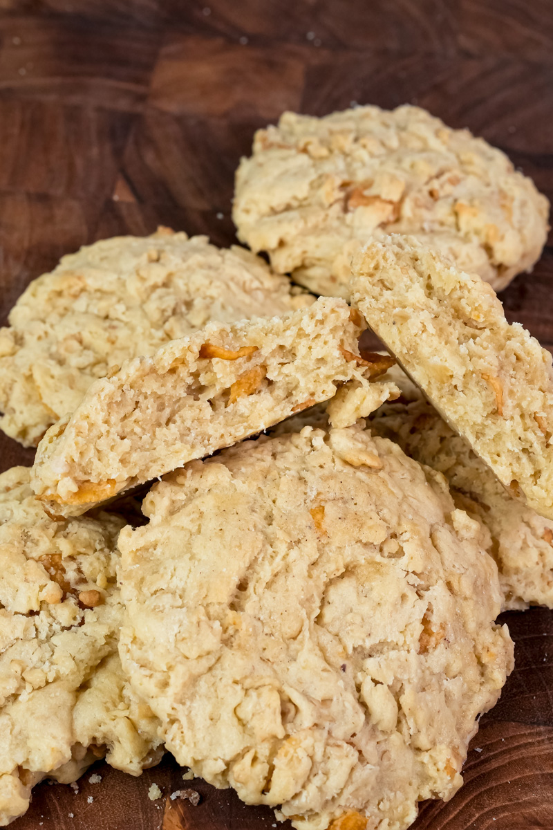 Freshly baked ranger cookies with oats and coconut flakes on wooden cutting board