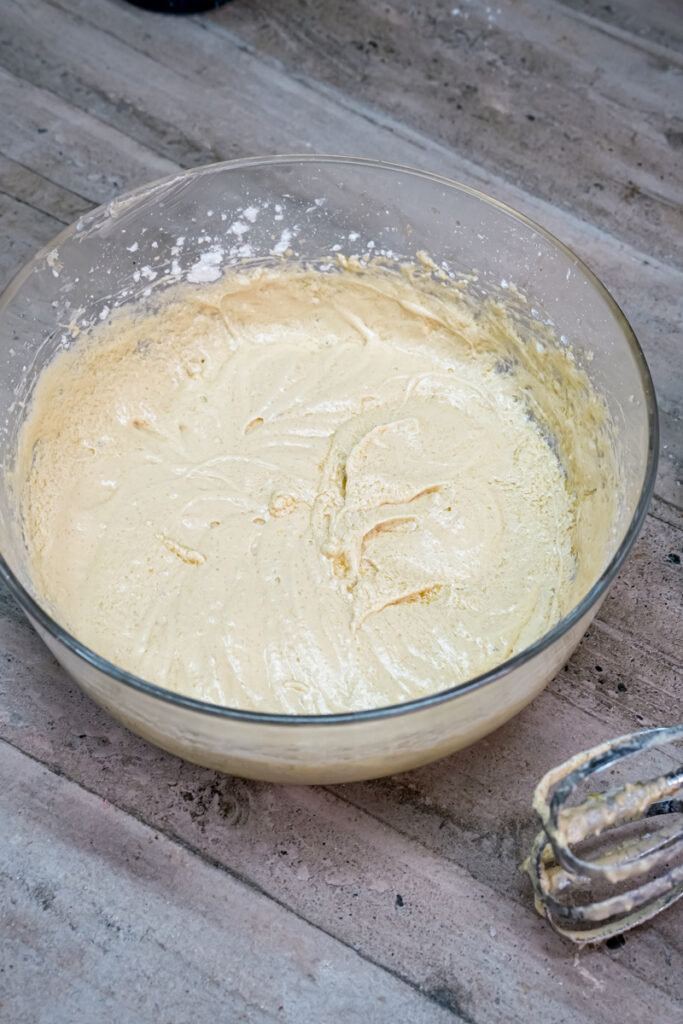 Fully mixed wet ingredients, a creamy cookie dough base, in a glass bowl