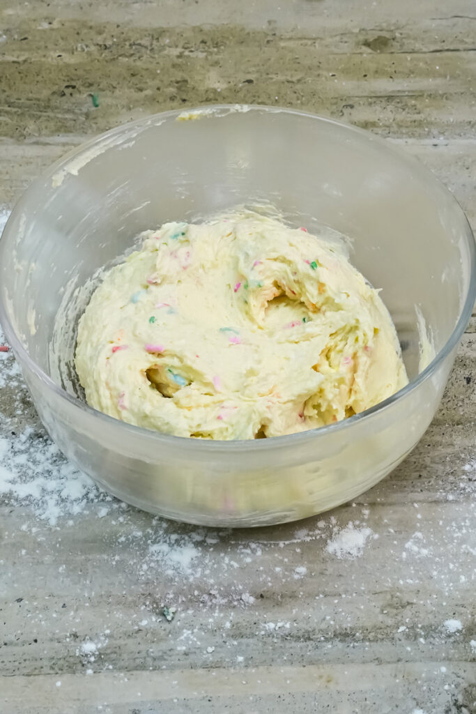 Finished Funfetti cookie dough in a clear bowl