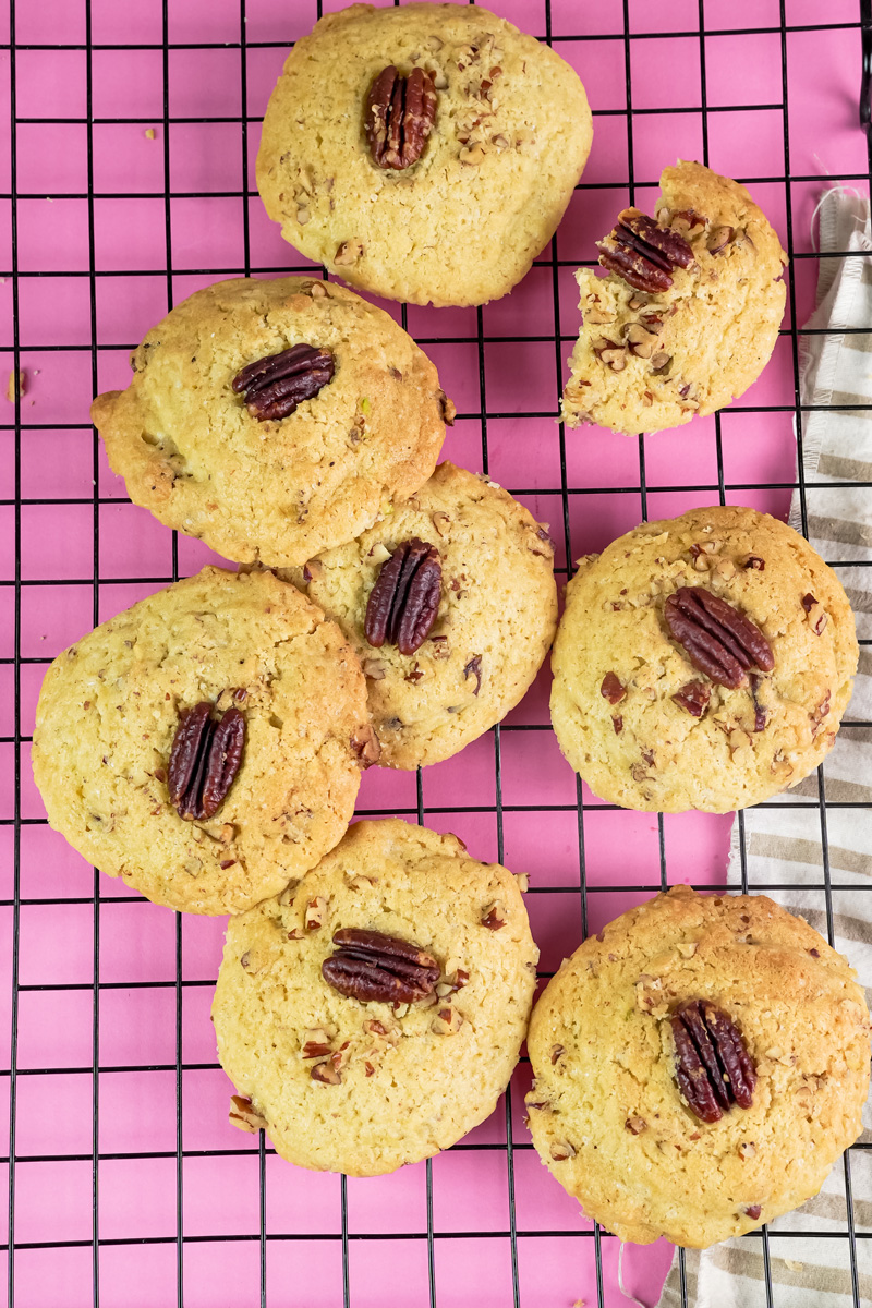 Golden brown Pecan Pie cookies on a pink background