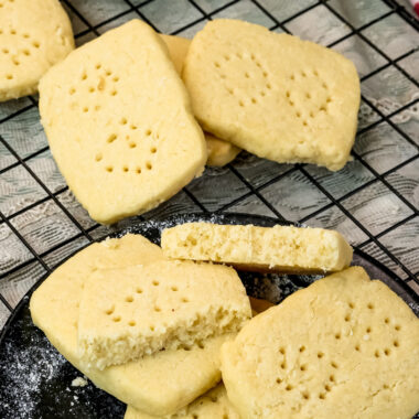 Golden shortbread cookies with fork holes cooling on wire cooling rack