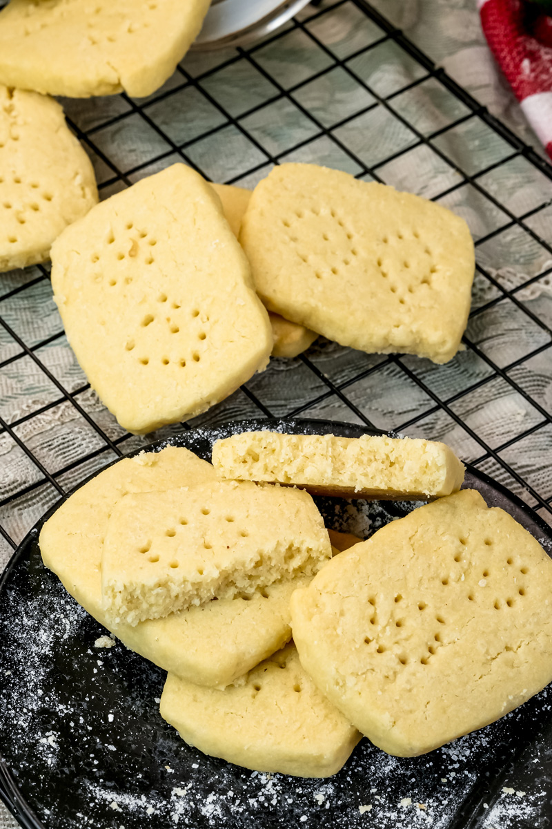 Golden shortbread cookies with fork holes cooling on wire cooling rack