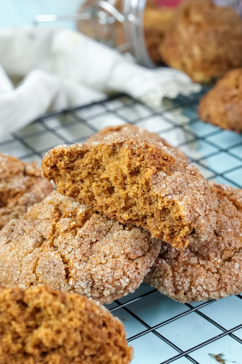Halved gingerbread cookie on a stack of cookies