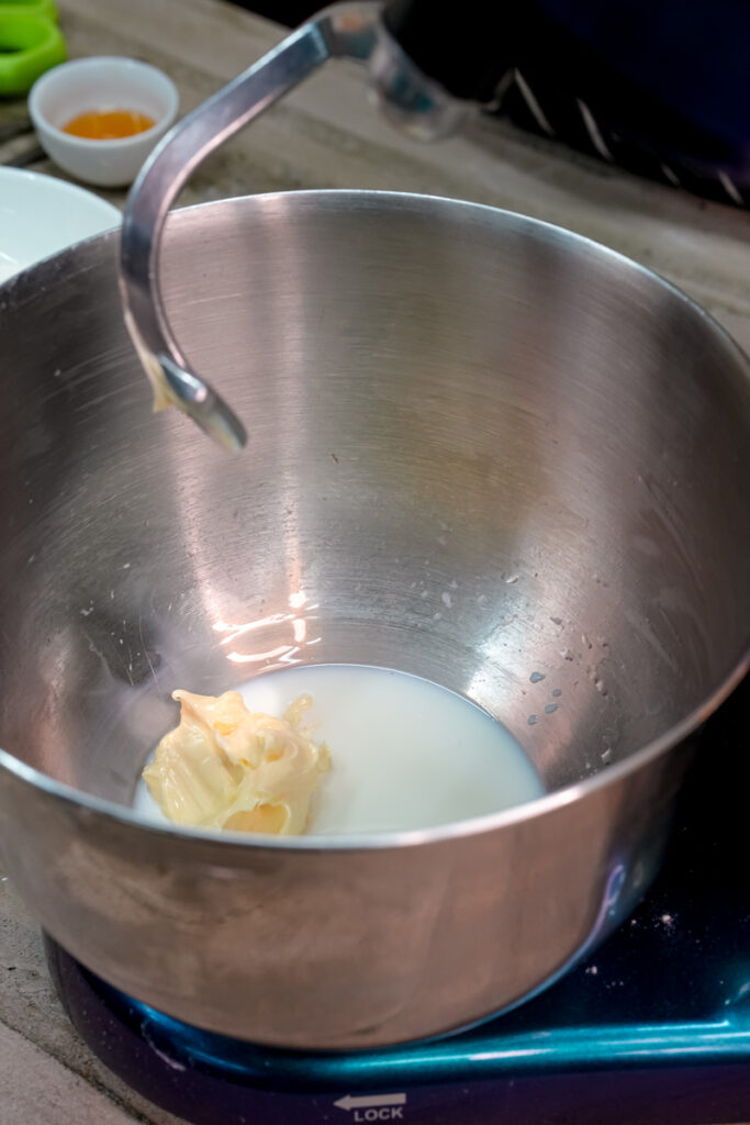 Heated milk with butter melting in saucepan for bread dough