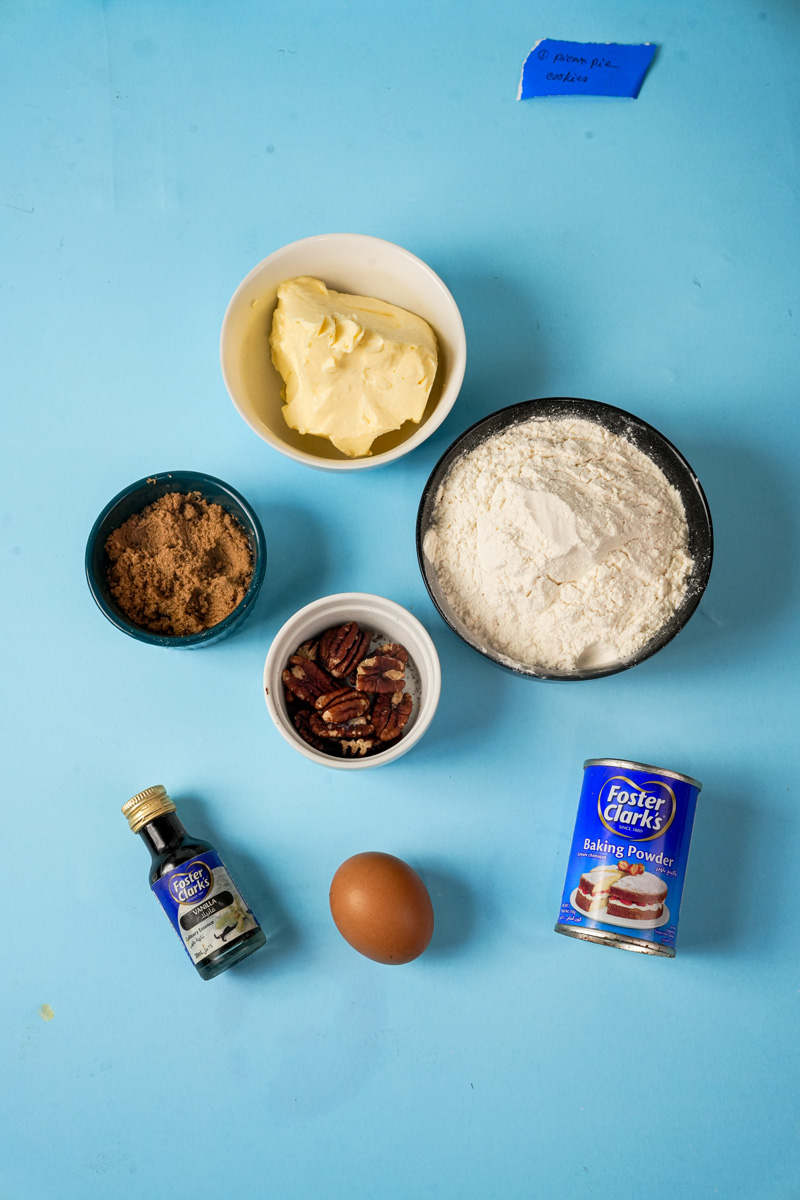 Ingredients for Pecan Pie Cookies on a blue background
