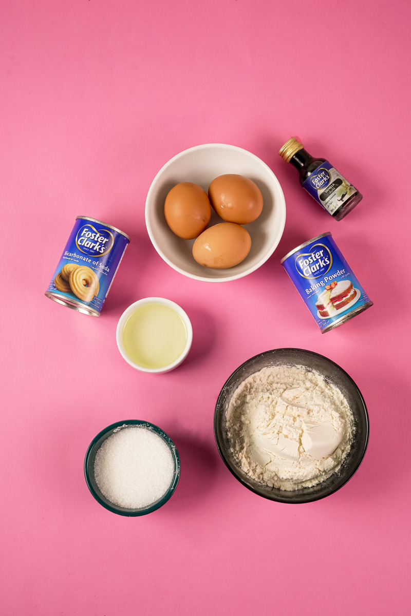 Ingredients for a drip cake recipe including eggs, flour, sugar, and baking powder