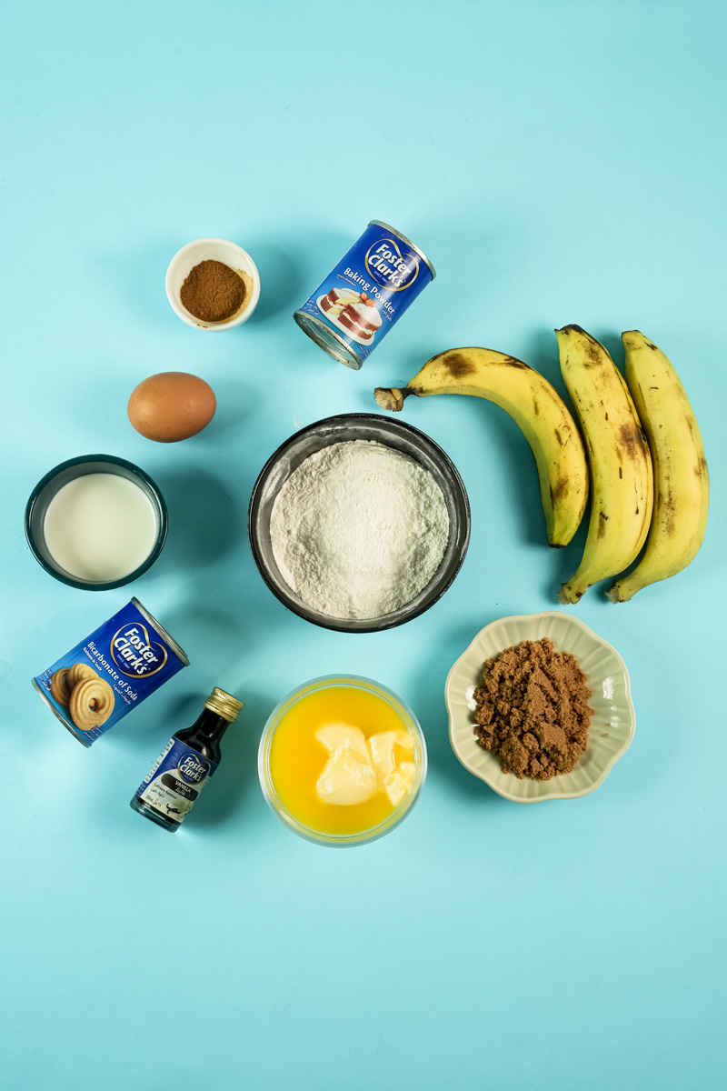 Ingredients for banana muffin recipe on a blue background