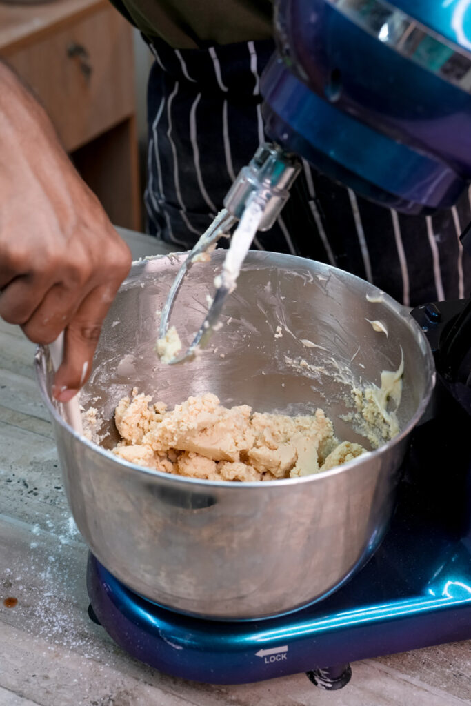 Mixing alfajores cookie dough ingredients with electric mixer