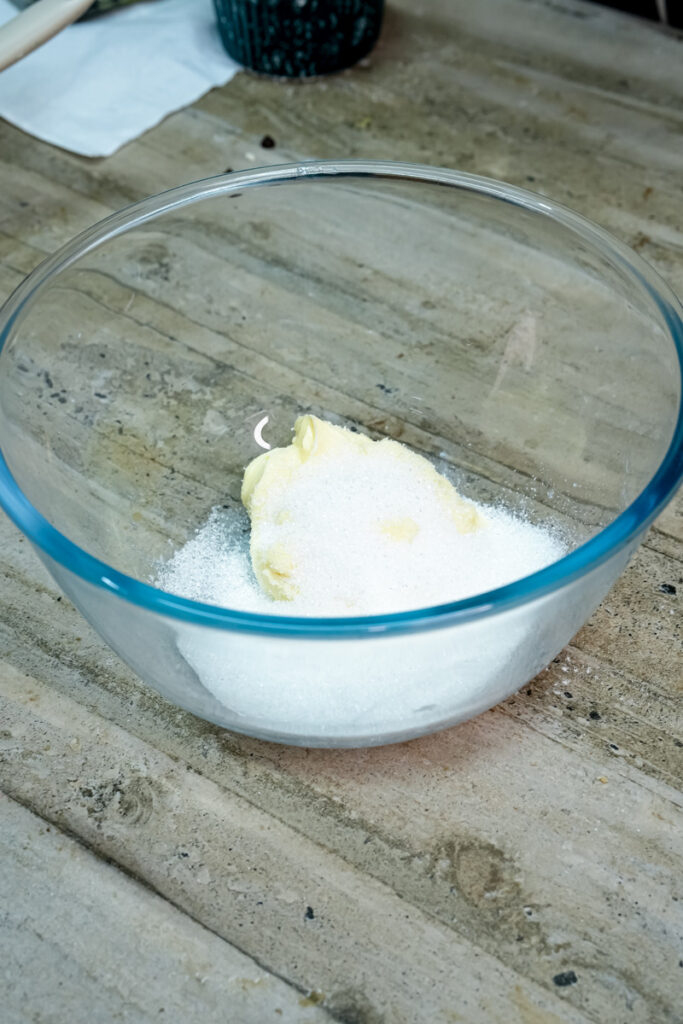 Mixing butter and sugar in a glass bowl to make churro cookie dough