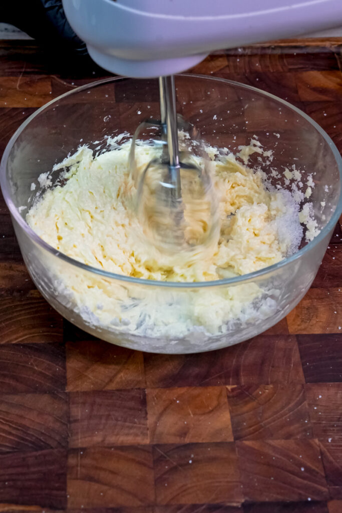 Mixing butter and sugar together with an electric hand mixer