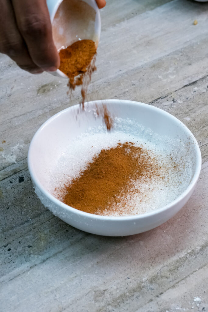 Mixing cinnamon and sugar for topping