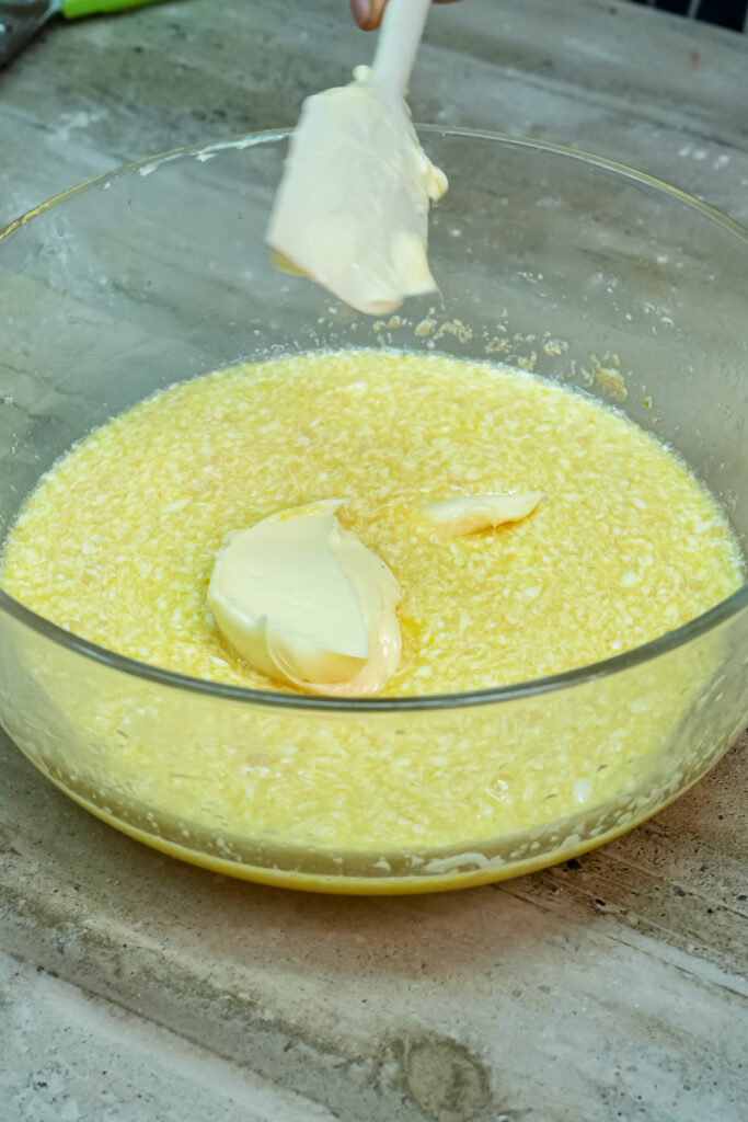 Mixing pan de muerto dough ingredients with wooden spoon