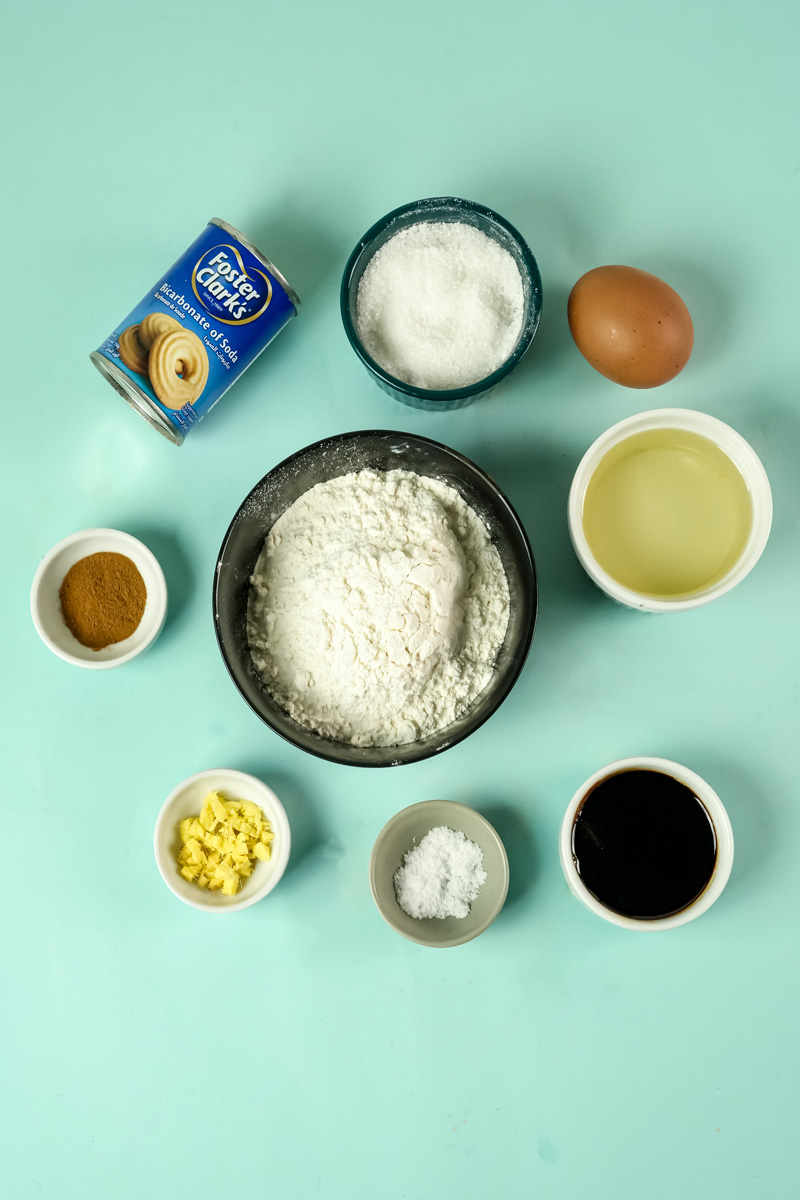 Molasses cookie ingredients including flour, molasses, egg and spices