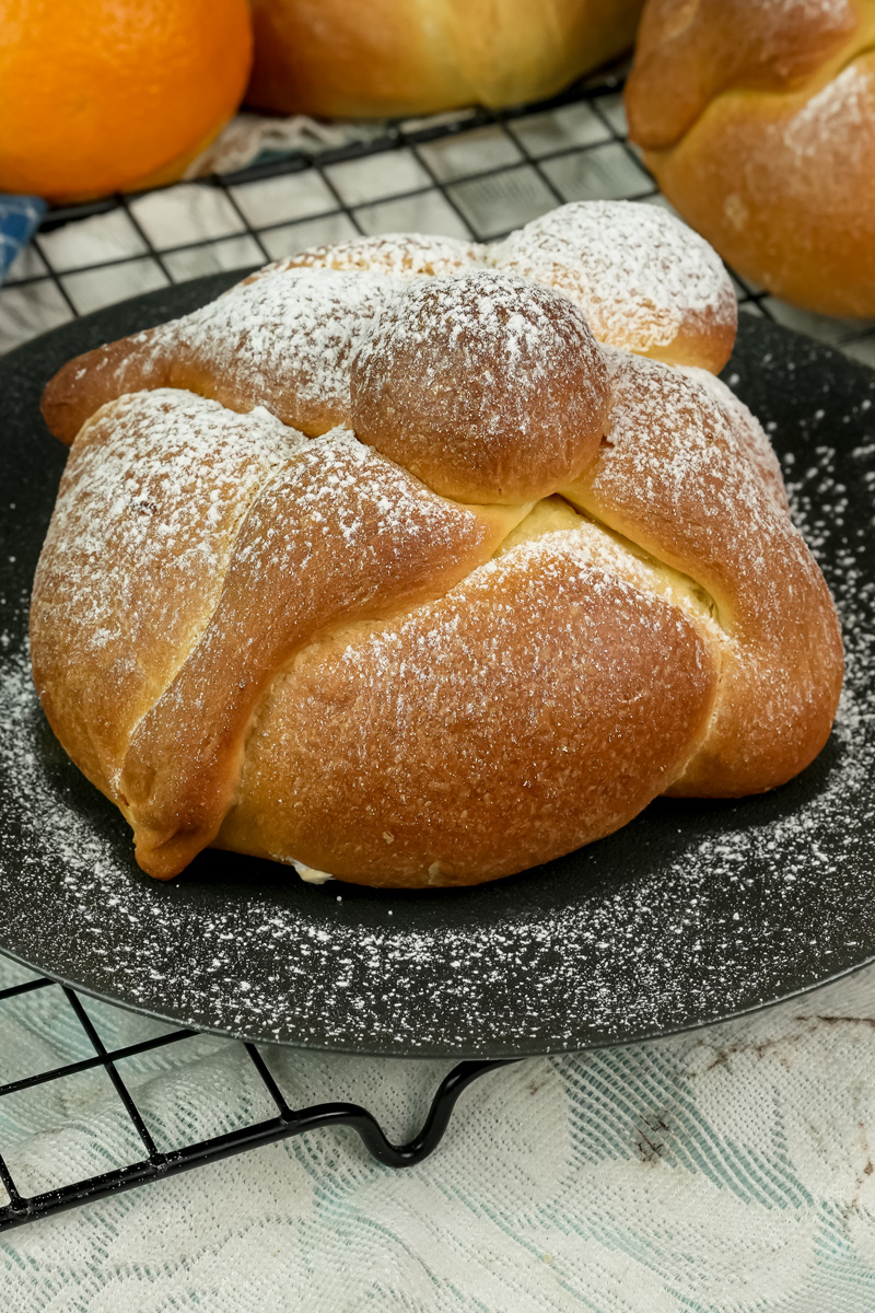 Close-up of authentic Pan de Muerto Mexican Day of the Dead bread with powdered sugar