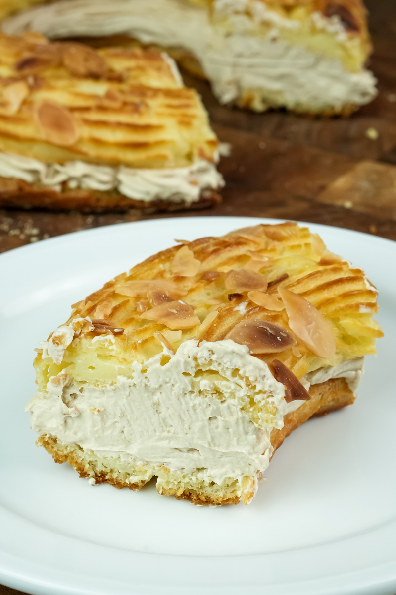 Close-up Paris Brest slice showing thick cream filling and choux pastry texture