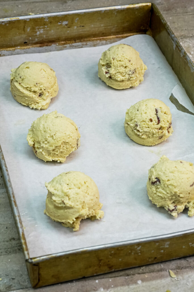 Pecan Pie cookie dough scoops on a parchment-lined baking sheet