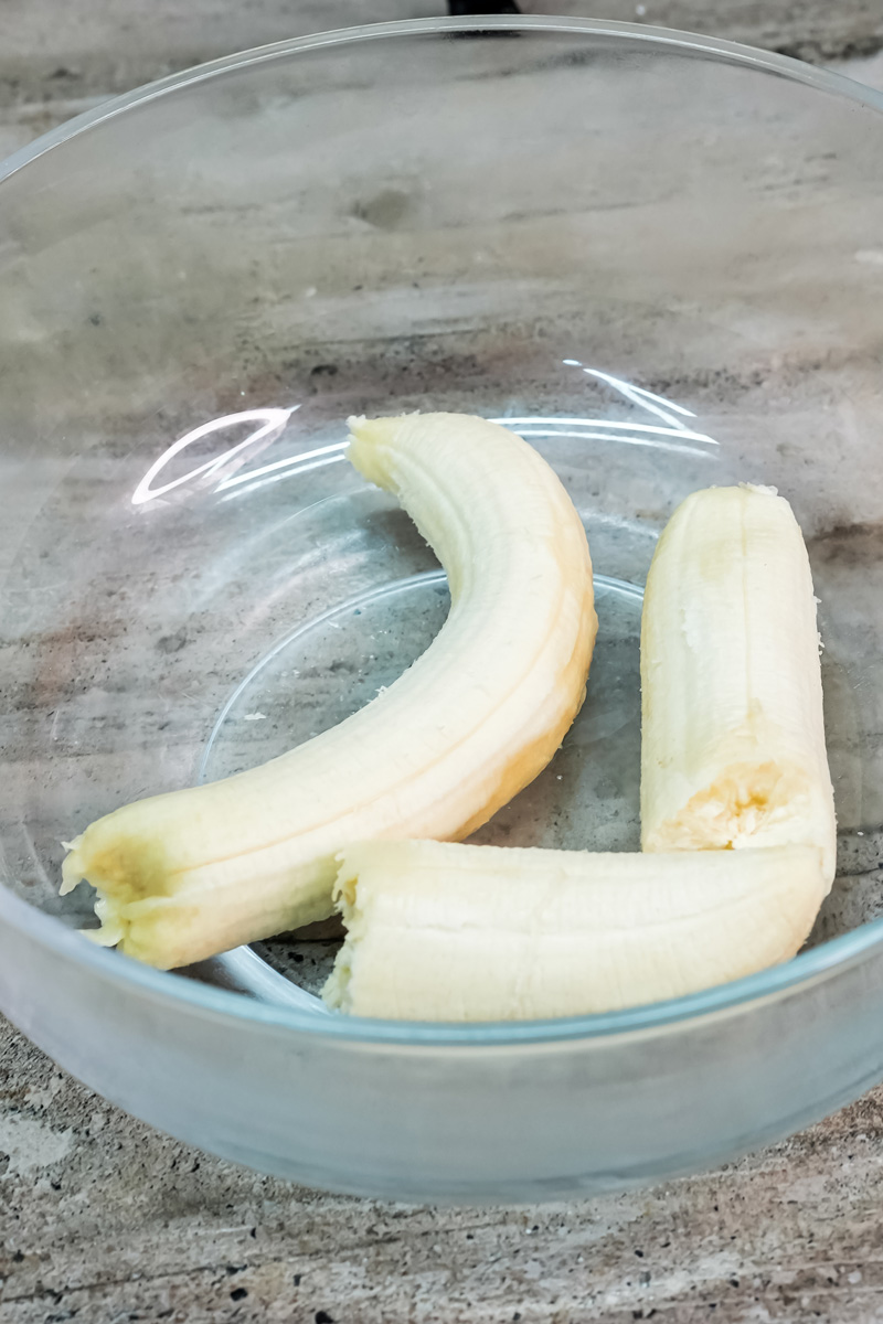 Peeled bananas in a glass bowl ready to be mashed