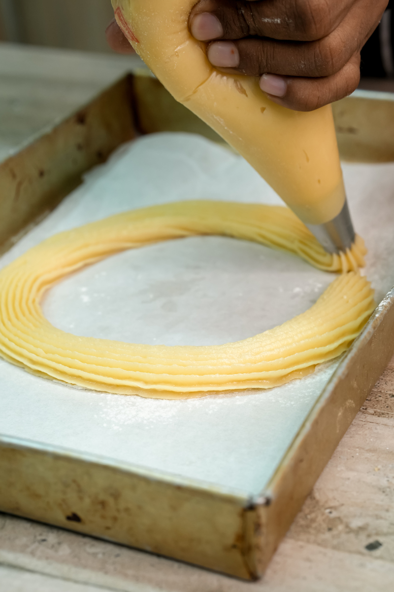 Creating concentric circles of choux pastry on baking sheet