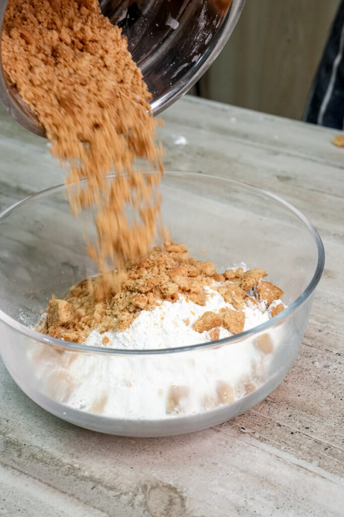 Pouring brown sugar into mixing bowl with flour