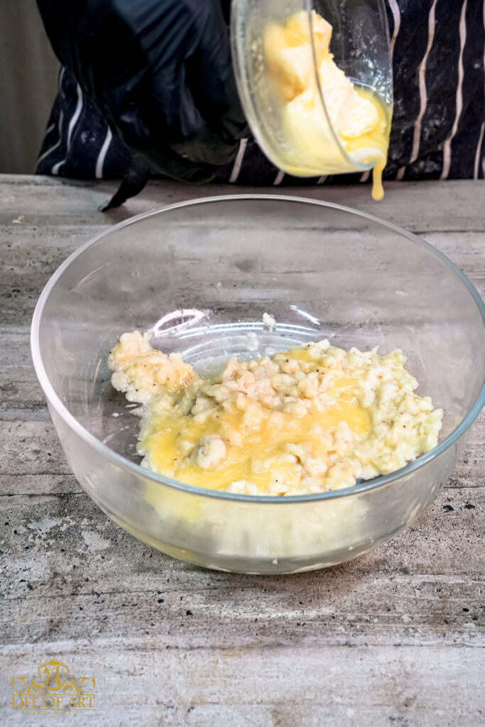 Pouring melted butter into the mashed bananas