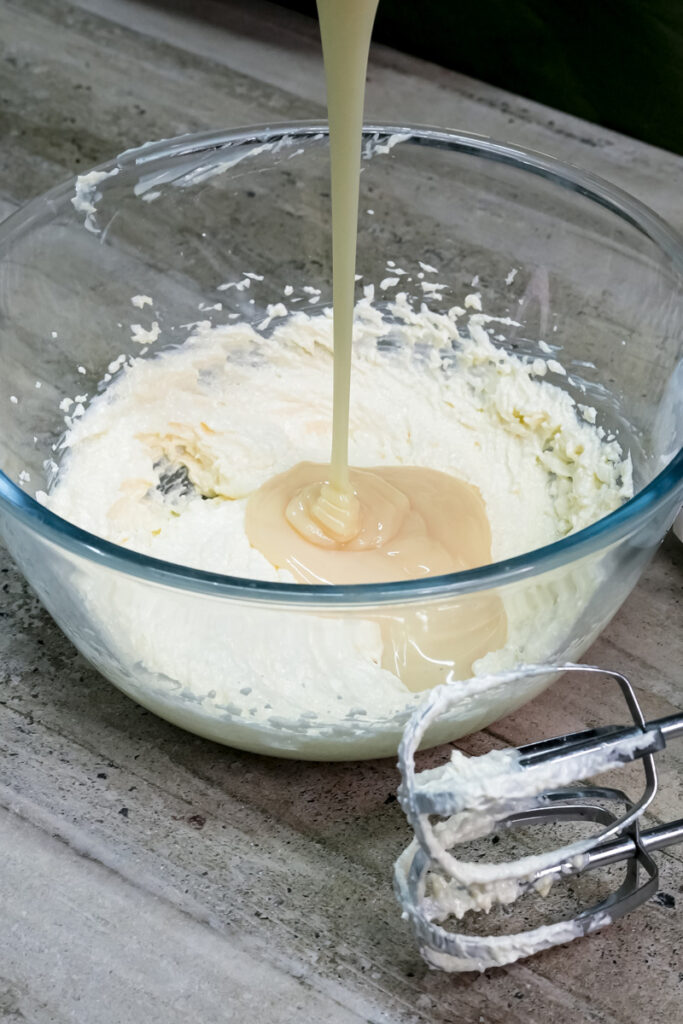 Pouring milk into cookie dough mixture