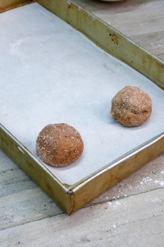 Raw gingerbread cookie dough balls on a baking sheet