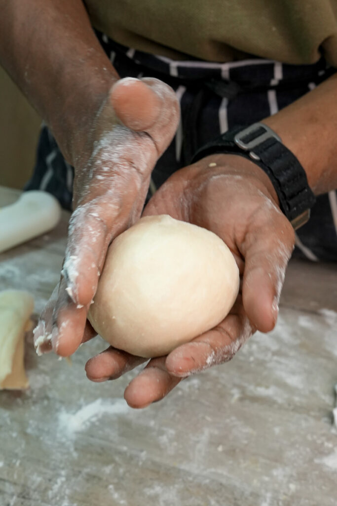 Shaping pineapple bun dough by hand