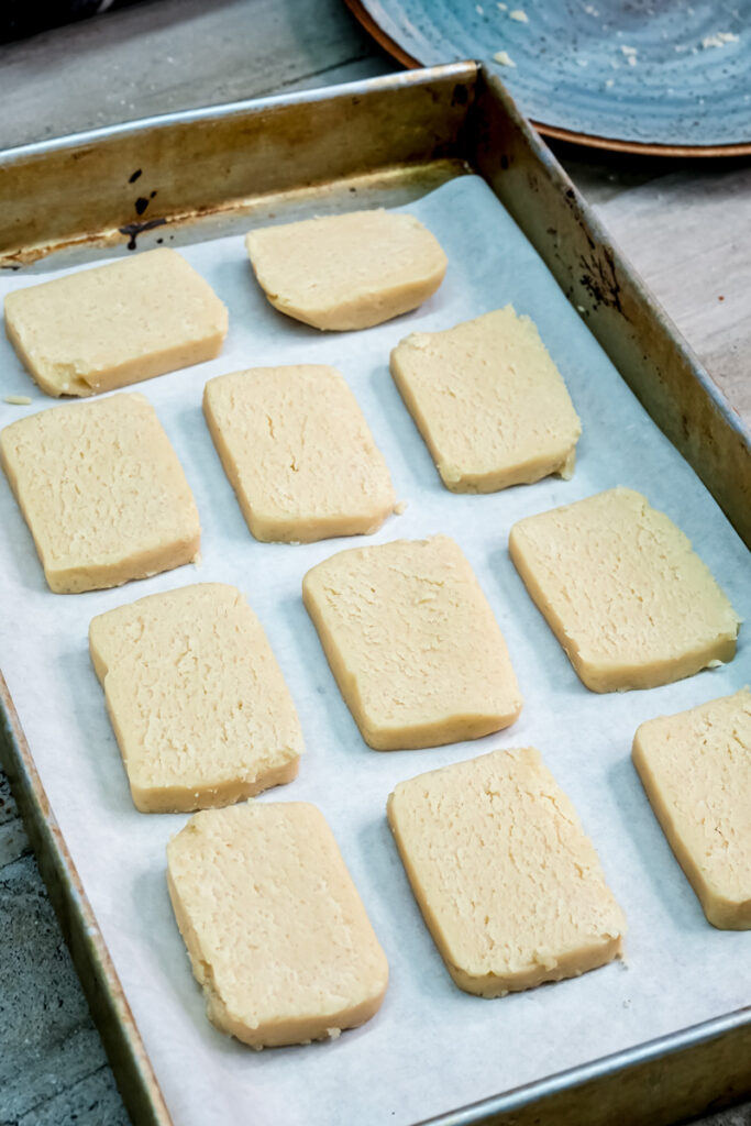 Shortbread cookie dough portions on parchment paper before baking