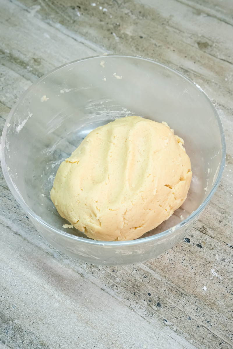 Shortbread cookie dough formed into ball in mixing bowl