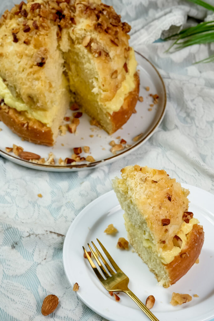 Bee sting cake slice with visible cream filling and caramelized almond topping