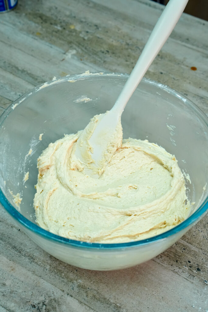 Smooth, creamy cookie dough in a glass mixing bowl