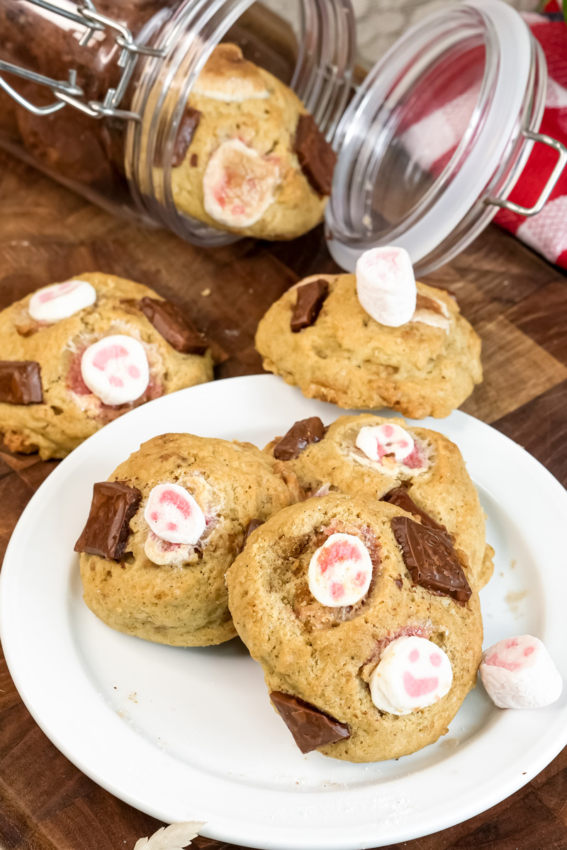 S'mores cookies with glass jar storage on wooden surface