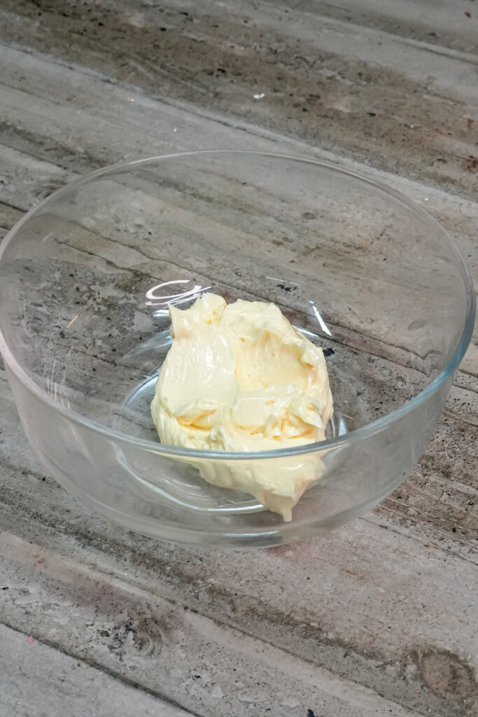 Softened butter in glass mixing bowl for cowboy cookies