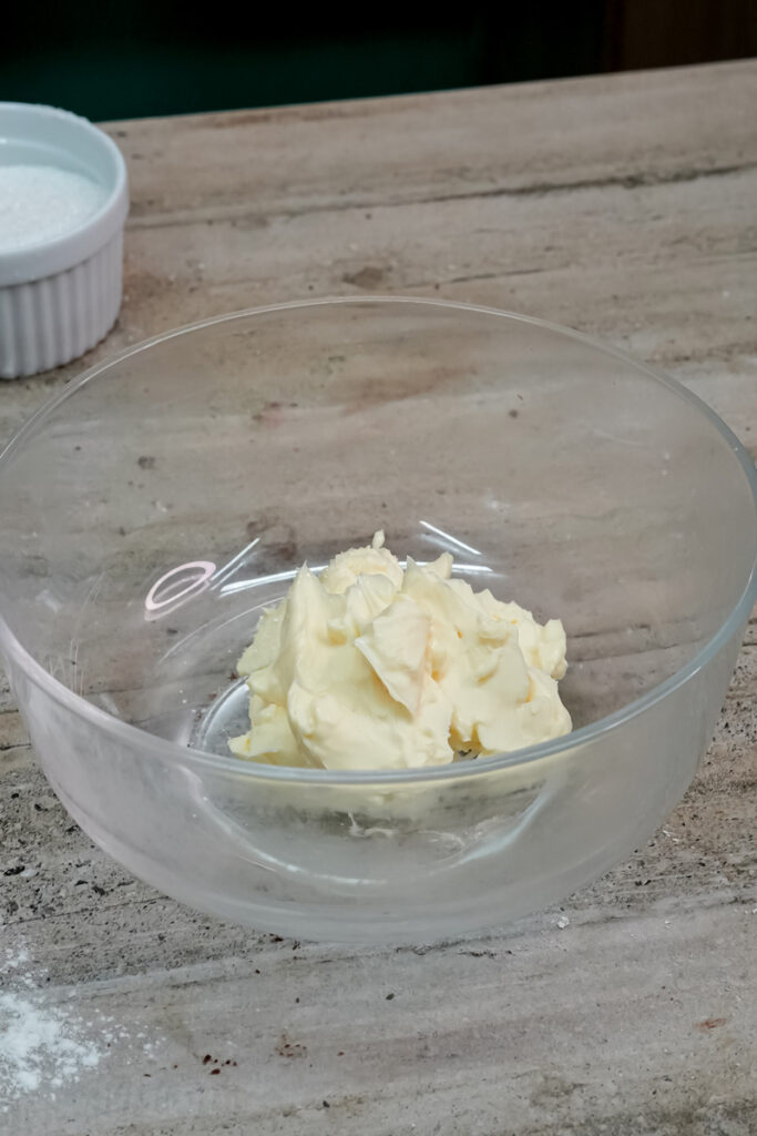 Softened butter in glass mixing bowl for Twix cookie dough