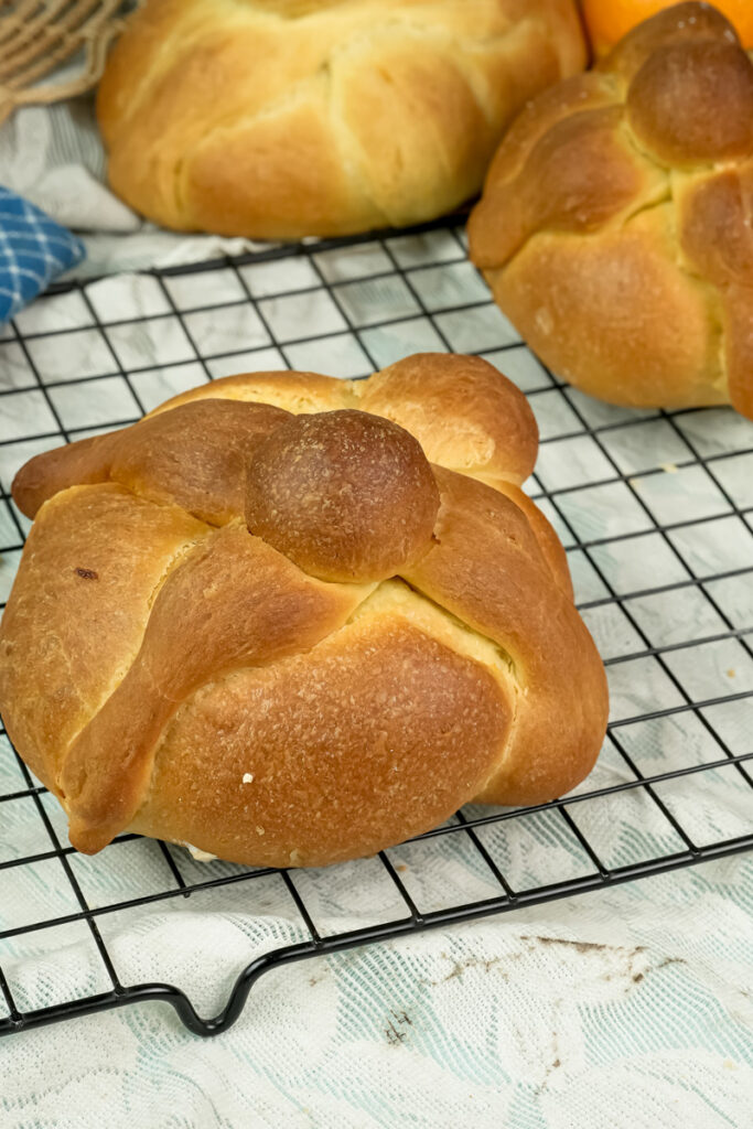 Traditional Mexican pan de muerto bread cooling on wire rack