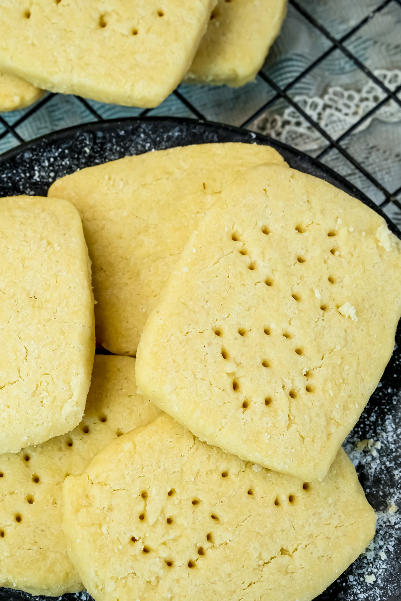Traditional shortbread cookies with dotted pattern on dark serving plate