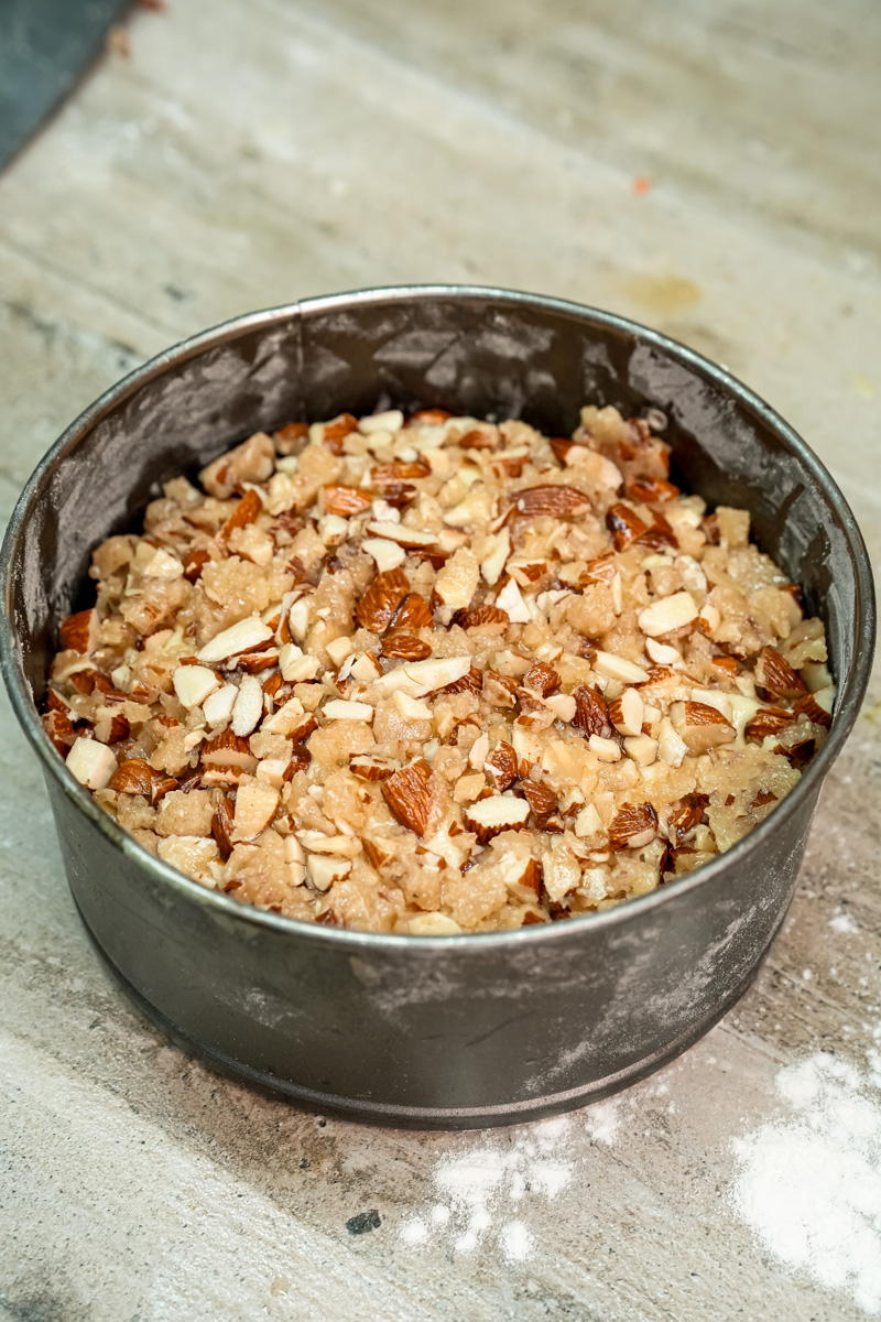 Unbaked bee sting cake showing almond topping distribution in cake pan