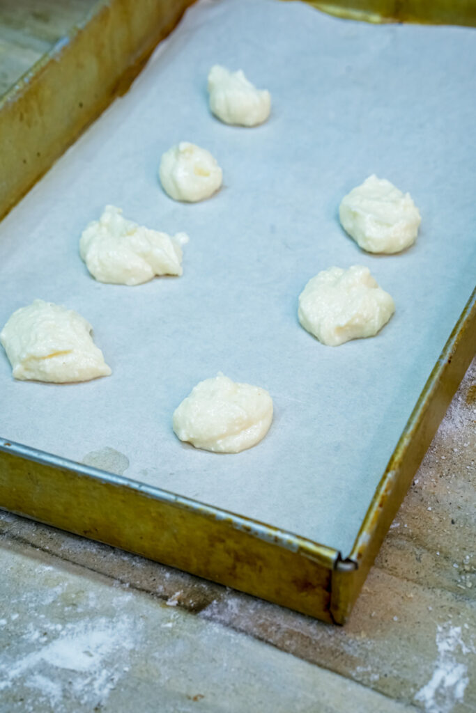 Unbaked cheesecake cookies on parchment paper