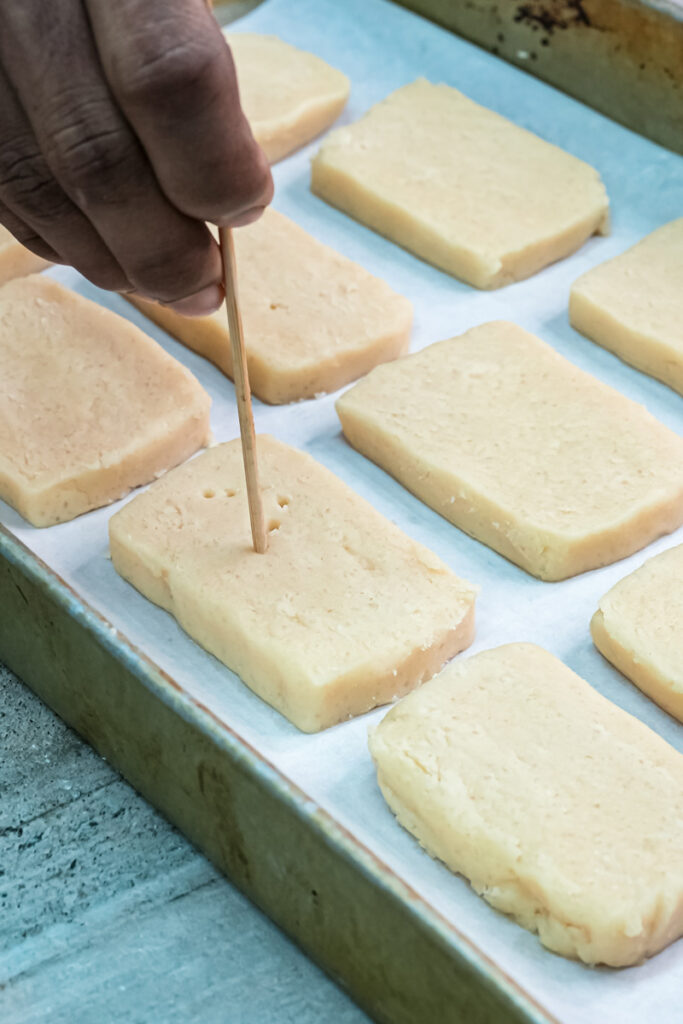 Using toothpick to create holes in shortbread cookie dough before baking