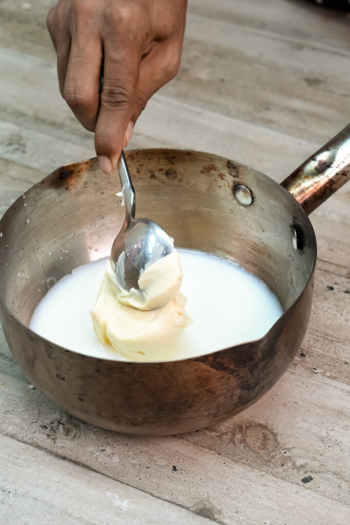 Whisking butter into warm milk for Paris Brest cream