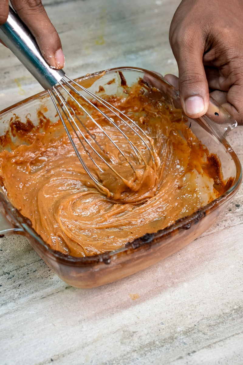 Whisking homemade dulce de leche for alfajores filling