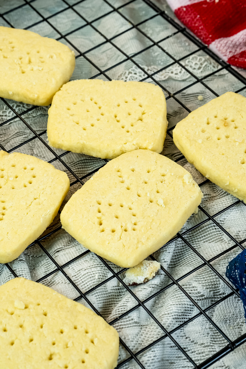 Perfectly baked shortbread cookies cooling on wire rack after baking