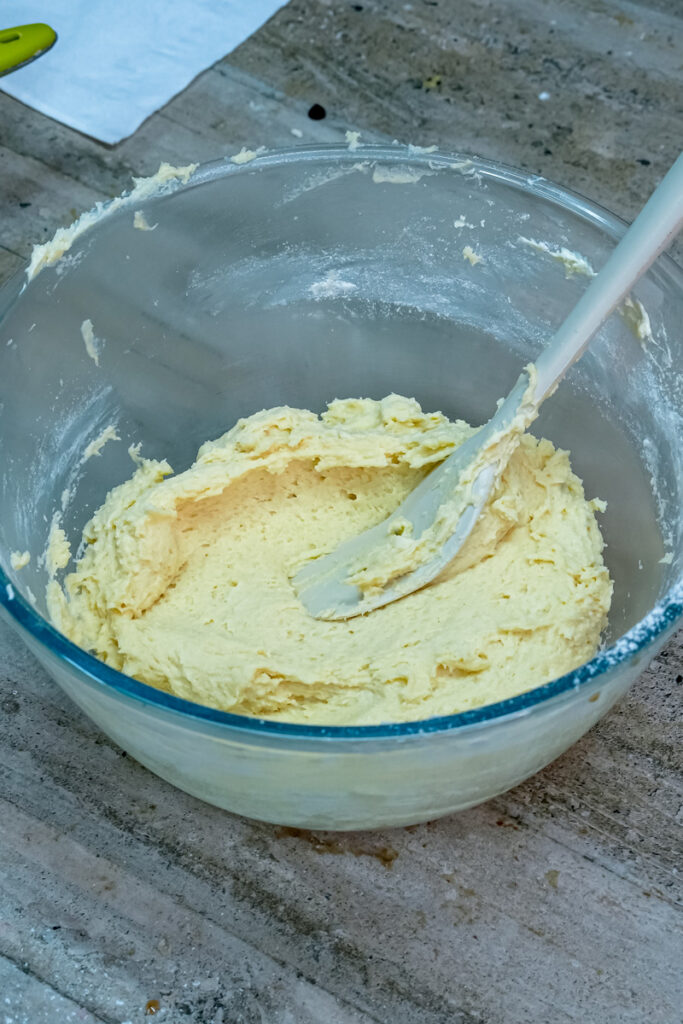 A glass bowl of finished churro cookie dough ready to be piped